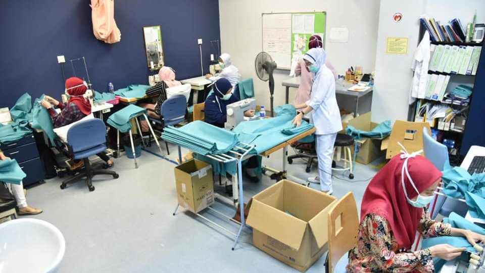 Medical workers in Malaysia manufacturinng protective gears in a photo dated April 15, 2020. Photo: Health Ministry Malaysia/Facebook