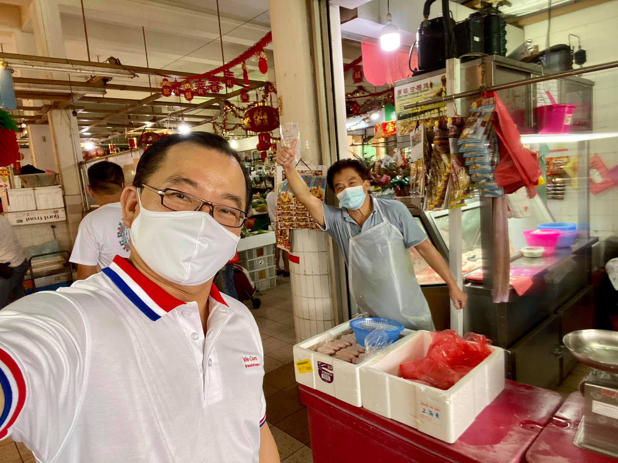 MP Seah Kian Peng poses for a wefie with a market vendor Sunday morning. Photo: Seah Kian Peng/Facebook