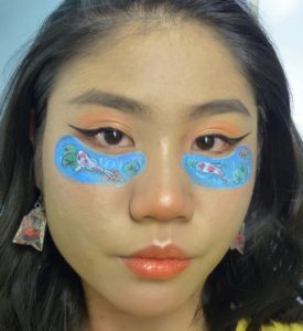 Lee paints a pair of koi ponds under her eyes, accompanied with matching earrings. Photo: Lee Ming Hui / Instagram