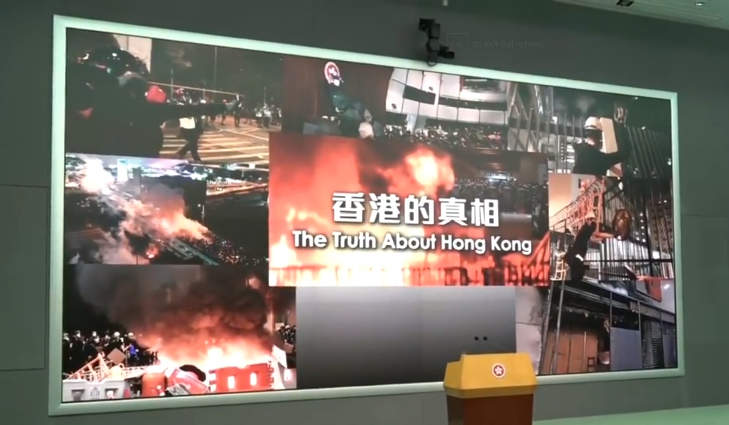 Yes, this is the actual backdrop that Carrie Lam stood in front of at a government press briefing. Screenshot: RTHK via Facebook