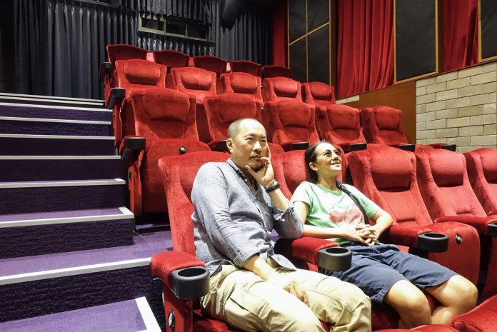 Artists and filmmakers Manit Sriwanichpoom and Ing Kanjanavanit sit inside their Cinema Oasis in Soi Sukhumvit 43.