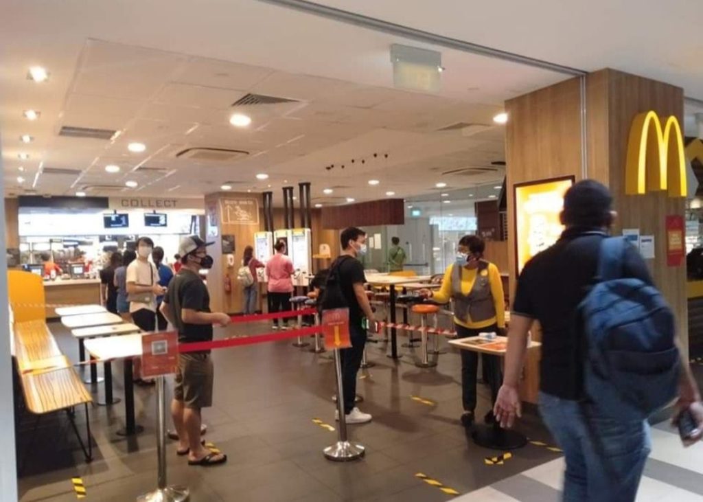 Customers queue for temperature scanning at a McDonald’s outlet. Photo: Legit Singapore/Facebook