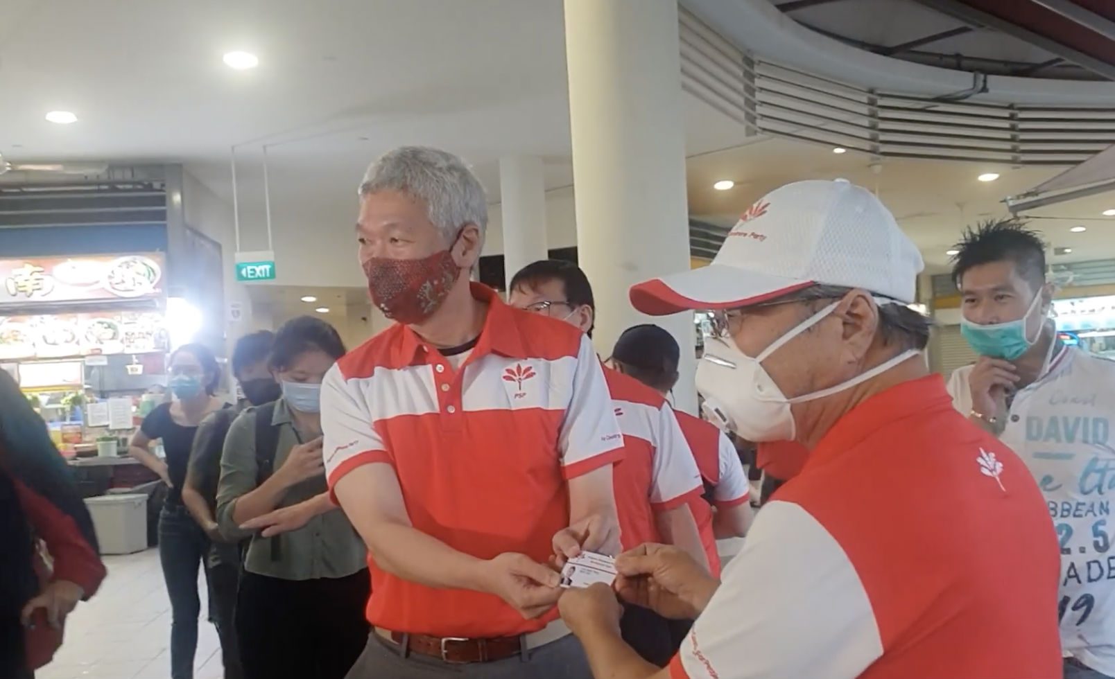 Lee Hsien Yang receives Progress Singapore Party membership card from Tan Cheng Bock. Photo: Yahoo/Facebook video