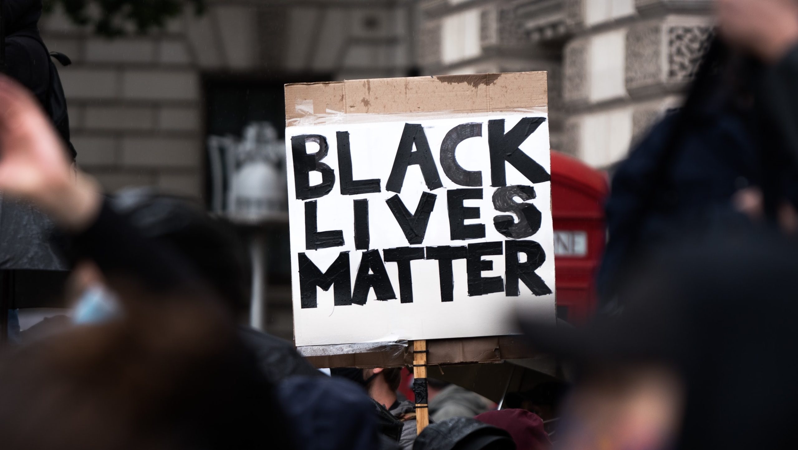 A protester holds up a Black Lives Matter sign. Photo: James Eades/Unsplash