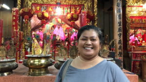 Penprapa “Nok” Sowsum stands in front of the Tubtim goddess that her husband’s family has cared for since the reign of King Rama V. Photo: Coconuts