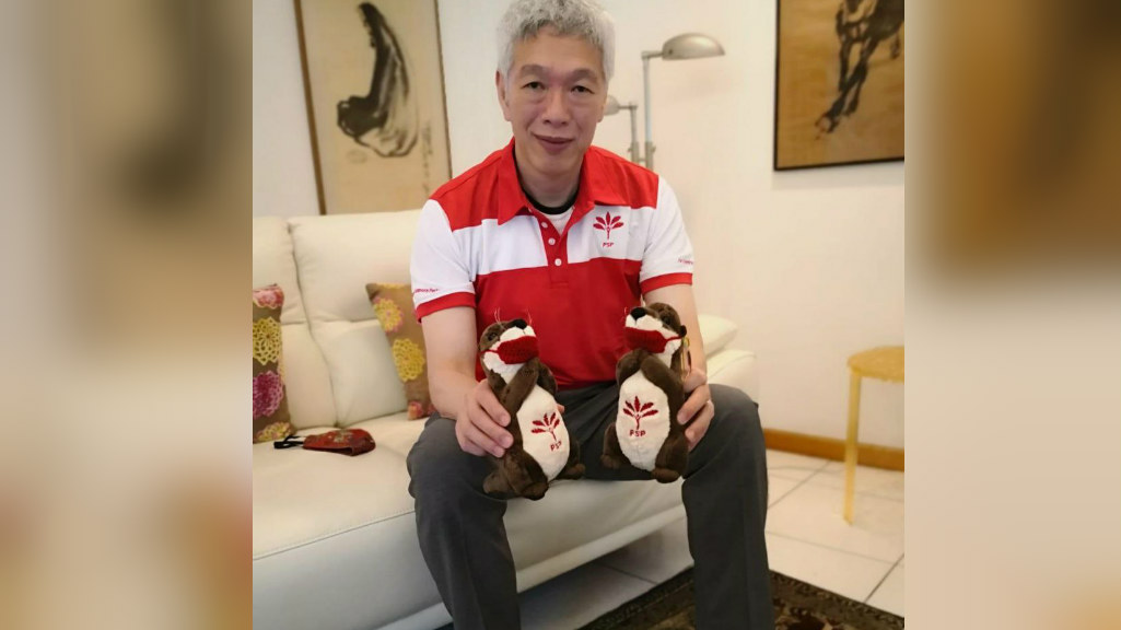 Lee Hsien Yang poses in party t-shirt and merch. Photo: Progress Singapore Party/Facebook