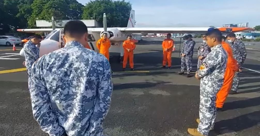 Members of the Philippine Coast Guard pray before starting their search and retrieval operations to find the missing fishermen. Screenshot from PCG’s video