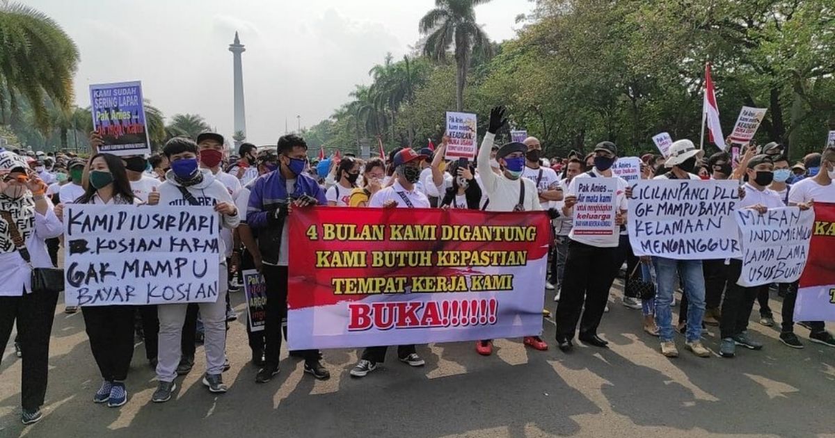 Hundreds of business owners and workers from the leisure sector came out to protest in front of Jakarta City Hall today (July 21), bringing posters and banners written with messages such as “We’re kicked out of our kost (boarding houses) because we’re unable to pay the rent”, “We have been hanged for four months, we need certainty, open our workplaces!”, and “We’re always eating Indomie we might get appendicitis”. Photo: TMC Polda Metro