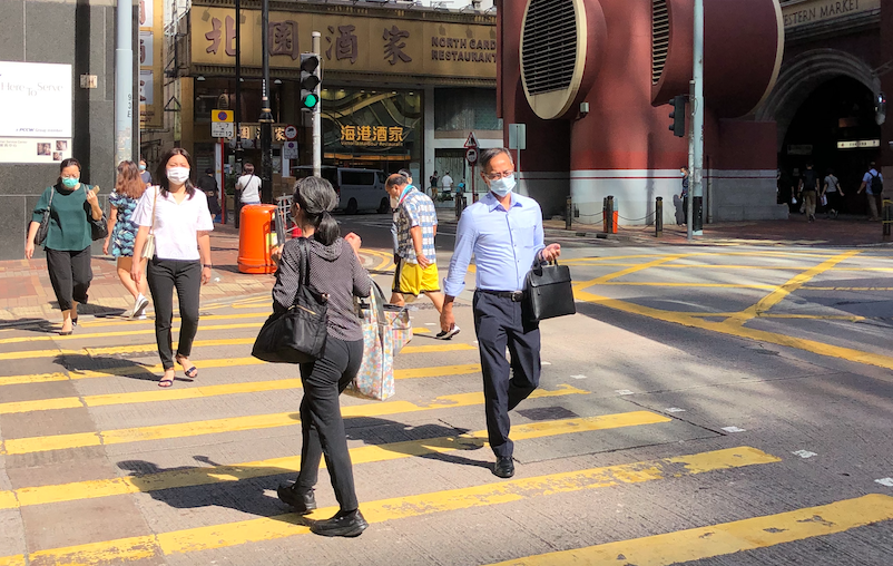 Pedestrians wearing face masks cross a road in Sheung Wan on July 13, 2020. Photo: Coconuts Media