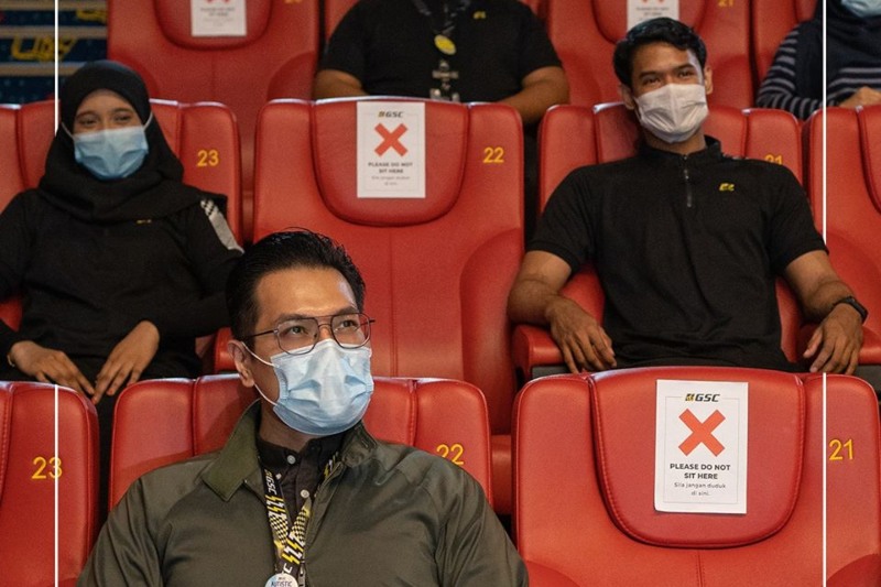 GSC staff pose as cinemagoers sitting one seat apart. Photo: GSCinemas /Facebook
