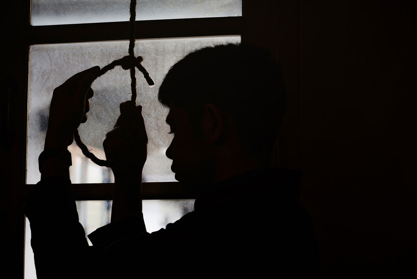 File photo of a man’s silhouette and a rope by the window. Photo: Freedom Studio
