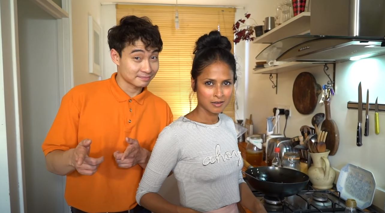 Nigel Ng, at left, and BBC presenter Hersha Patel speak into the camera in Patel’s home kitchen. Photo: Nigel Ng /YouTube