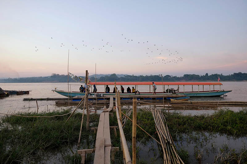 A ferry moored at the shore of the Mekong in Chiang Khan district, northeast Thailand, bordering Laos. Photo: Eddie Gerald / Alamy