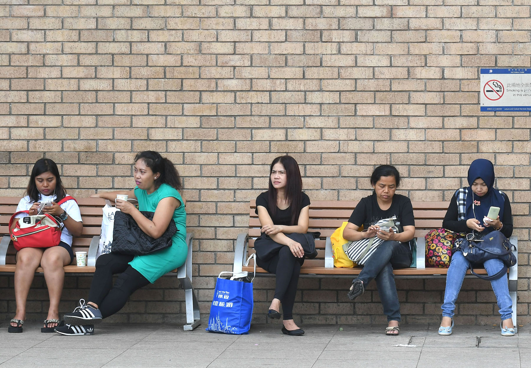 Domestic workers on their rest day at Victoria Park, Causeway Bay. Photo via the Hong Kong government’s Information Services Department