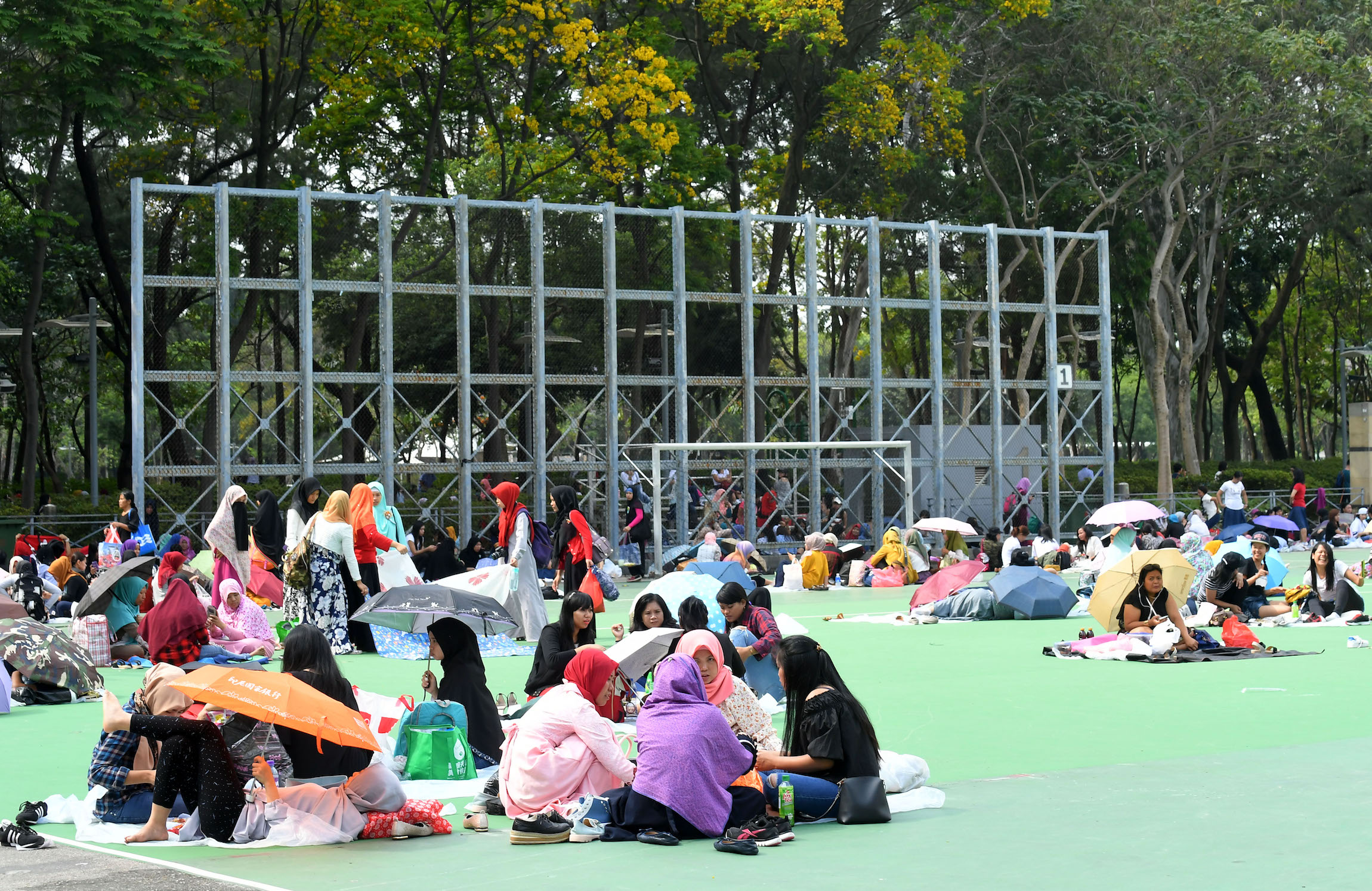 Domestic workers gather on their rest day at Victoria Park in Causeway Bay. Photo via the Hong Kong government’s Information Services Department