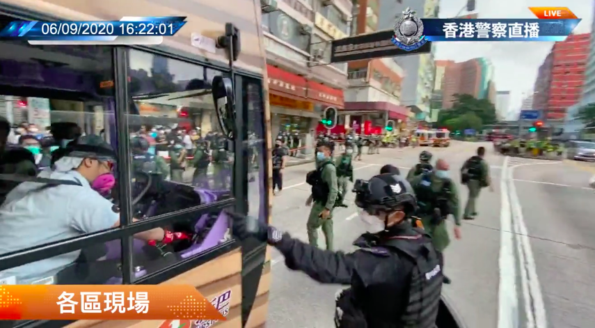 A police officer stops a 970 bus in Yau Ma Tei on Sept. 6, 2020. Screenshot via Hong Kong Police Facebook livestream