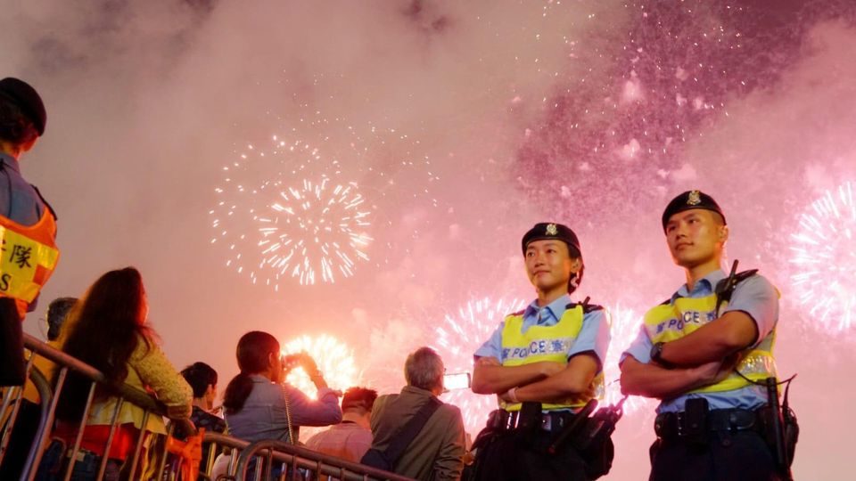 Hong Kong police officers pose in front of fireworks on Feb. 6, 2019. Photo via Facebook/Hong Kong Police Force
