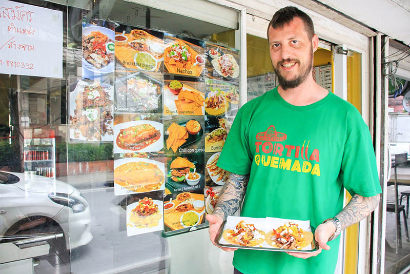 Colin Stevens poses in front of the newly opened Tortilla Quemada. Photo: Coconuts
