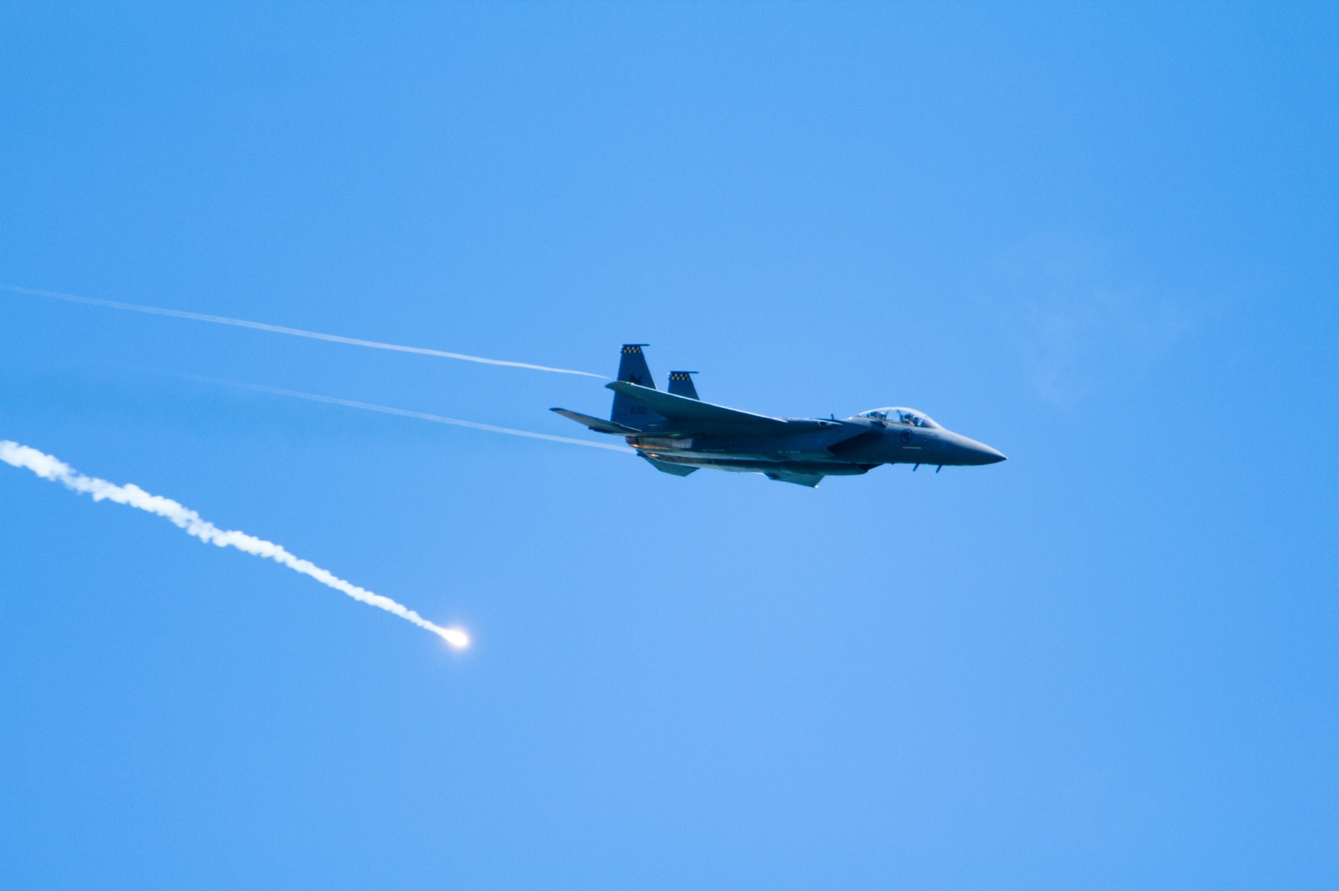 A RSAF F-15 releases a flare during a flyover for the Singapore Airshow 2020. Photo: Timothy Newman