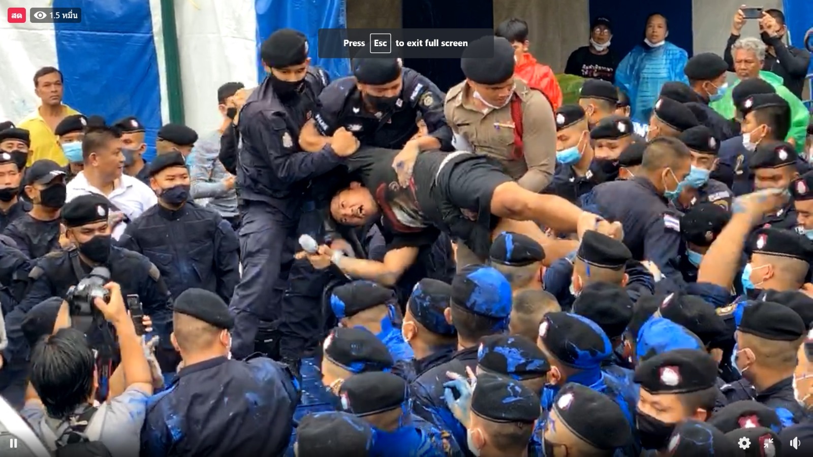 Jatupat ‘Pai Dao Din’ Boonpattarasaksa is carried away by police Tuesday afternoon in a still image captured from a live video of the incident. 
