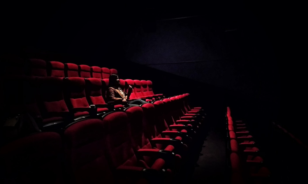 File photo of a woman sitting alone in a cinema. Photo: Karen Zhao
