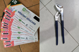 Stacks of grocery vouchers, at left, and a pair of pliers seized from a suspect. Photos: Singapore Police Force