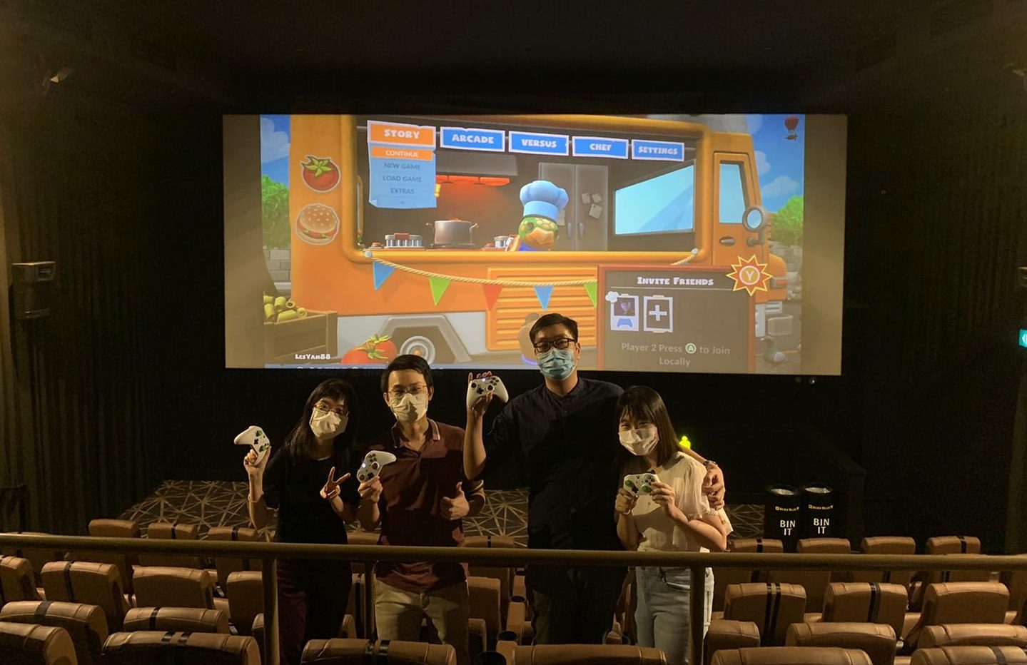 Overcooked: Gaming squad poses with their Xbox controllers in a cinema hall. Photo: Les Yam/Facebook

