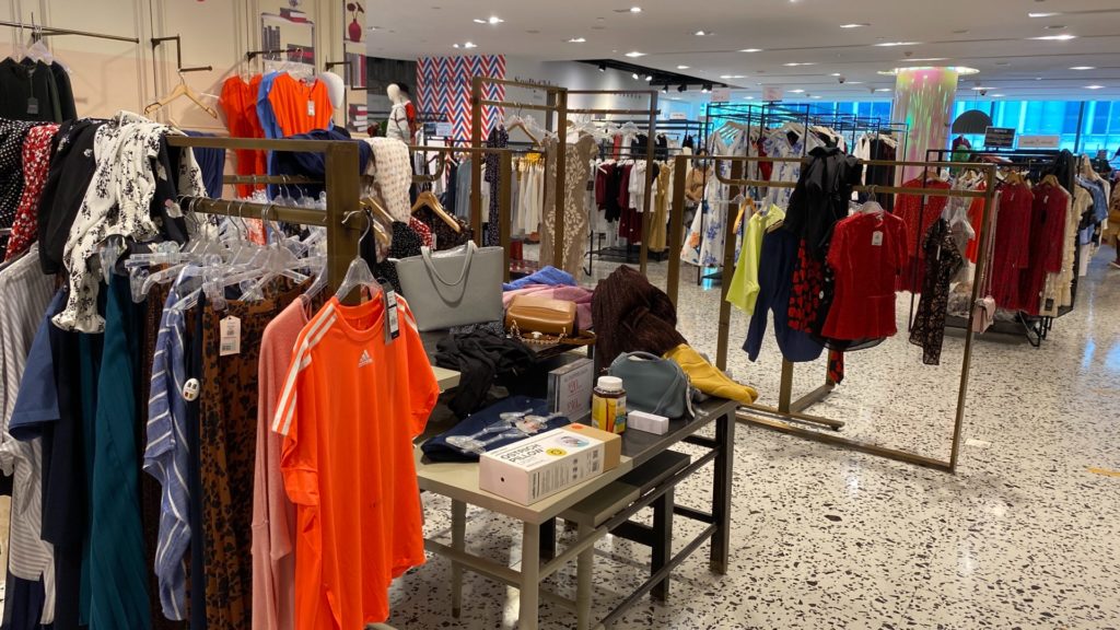 Clothing, some unhung, and other random items thrown everywhere at The Heeren outlet. Photo: Coconuts 