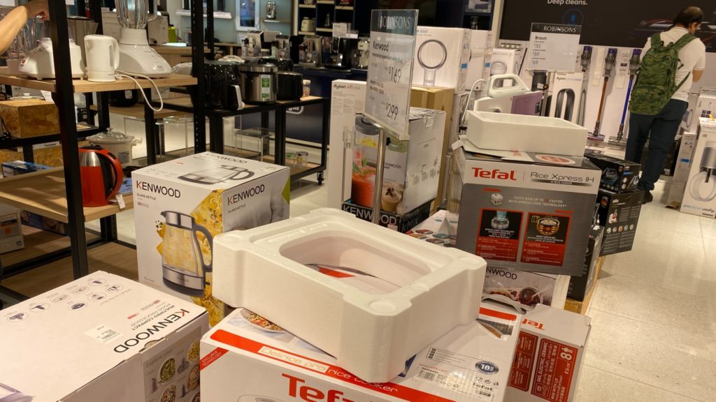 Opened boxes of household items at the Raffles City outlet. Photo: Coconuts