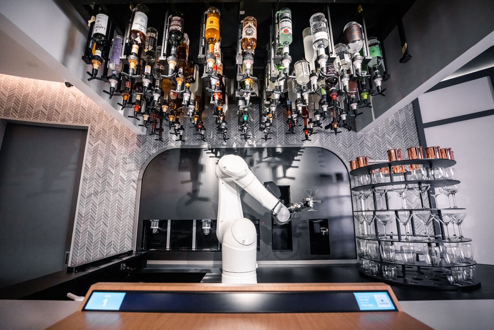 The robot bartender posing with a martini glass at its station. Photos: Ratio 

