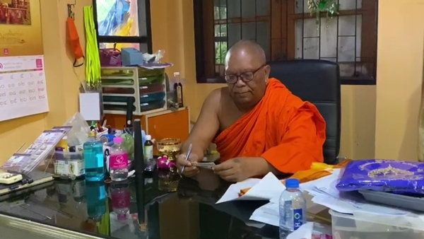 Ajahn Montri Samujjo checks his lottery ticket at Nonthaburi’s Wat Thinnakorn Nimit.