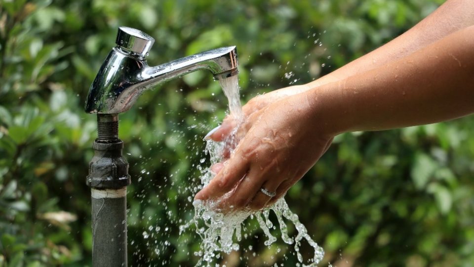 File photo of a person washing their hands by an outdoor tap. Photo: Macau Photo Agency
