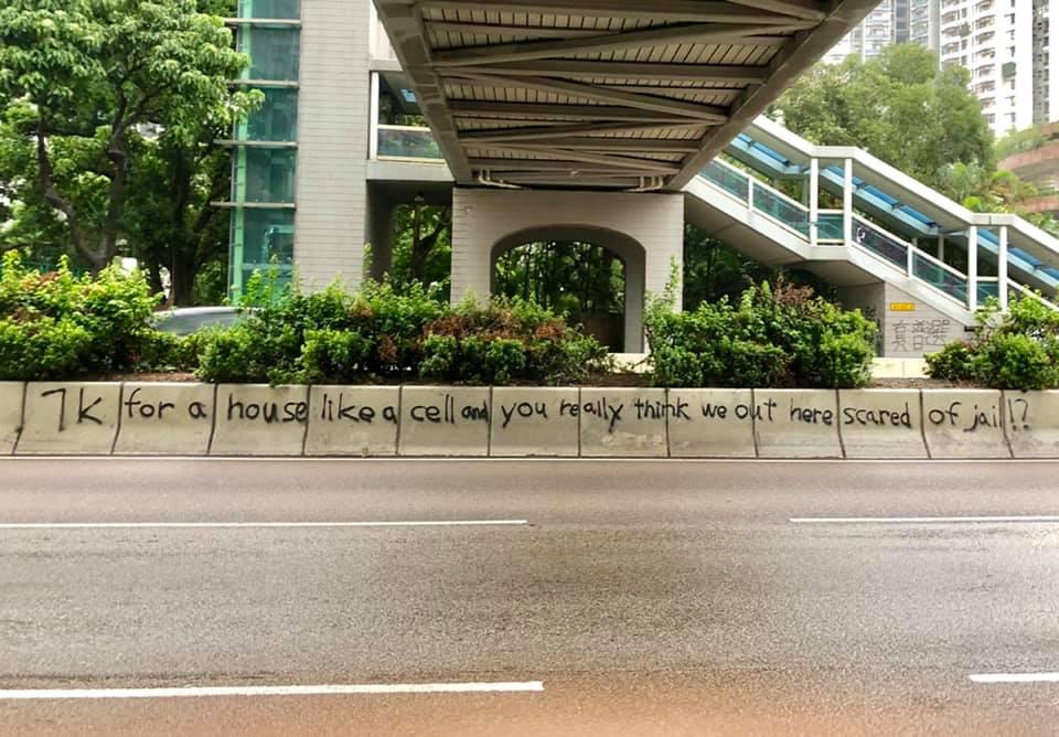 Lyrics from TXMIYAMA's track, 'TK,' graffittied on the road during the anti-extradition protests. Photo via Twitter/Joshua Wong
