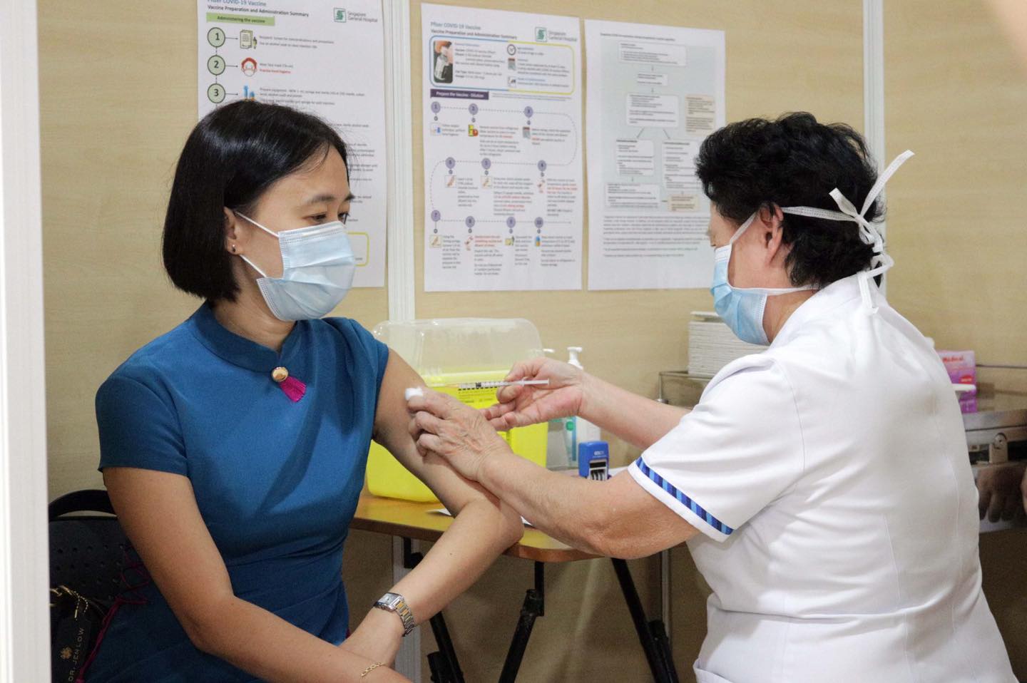 A nurse administers a COVID-19 vaccine to a woman at Singapore General Hospital. Photo: Singapore General Hospital
