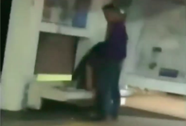 A woman performing oral sex on a man at a bus stop in Central Jakarta, as captured in a viral video.