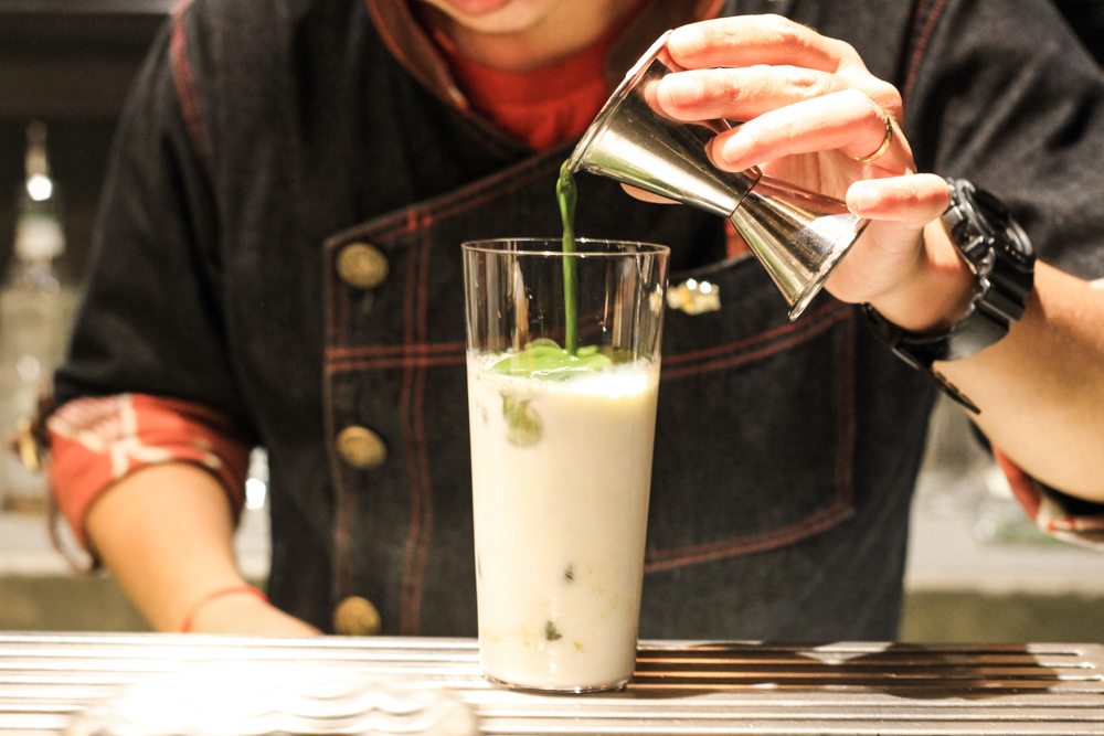 A bartender at Find the Locker Room preps We Are A Perfect Matcha (matcha, milk, hazelnut and strawberry whipped cream.) Photo: Coconuts
