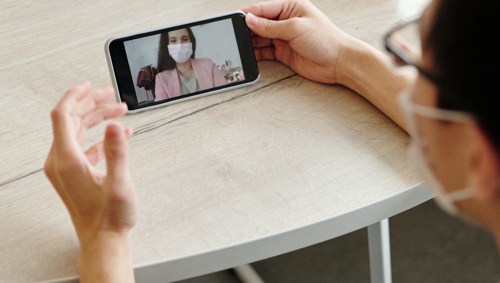A man speaks to a woman via video call. Photo: Edward Jenner