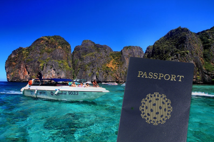 Tourists on a chartered yacht in Krabi’s Maya Bay with our imagined COVID passport. Original photo: Phalinn Ooi / CC BY 2.0