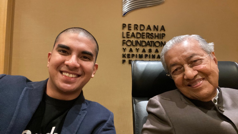 Syed Saddiq (left) poses with Mahathir Mohamad at the Perdana Leadership Foundation office yesterday. Photo: Syed Saddiq/Twitter