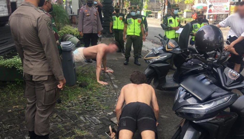 File photo from January 2021 of foreigners being subject to do push-ups for not wearing masks in Bali. Photo: Satpol PP Badung