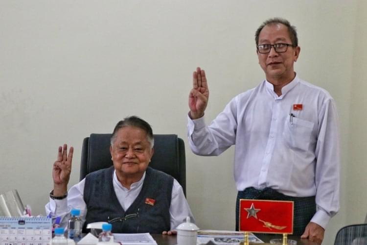 Win Htein, at left, and Kyi Toe of the National League for Democracy raise three-finger salutes in resistance to Myanmar’s coup. 
