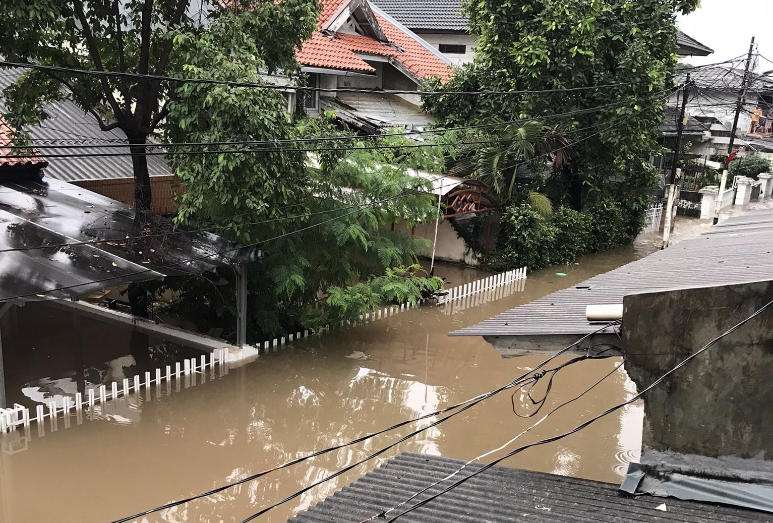 Floodwater almost submerging the first floor of houses in a neighborhood in Mampang, South Jakarta on Feb. 20. Photo: @infojakarta