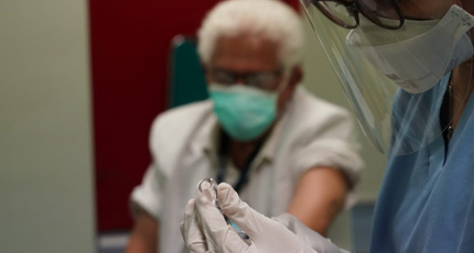 Photo of an elderly health worker getting vaccinated against COVID-19 in Indonesia. Photo: Indonesian Health Ministry