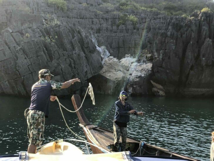 National park workers investigate the Prasat Hin Pan Yod, where a portion of the rock formation fell into the sea. Photo: Prachachat