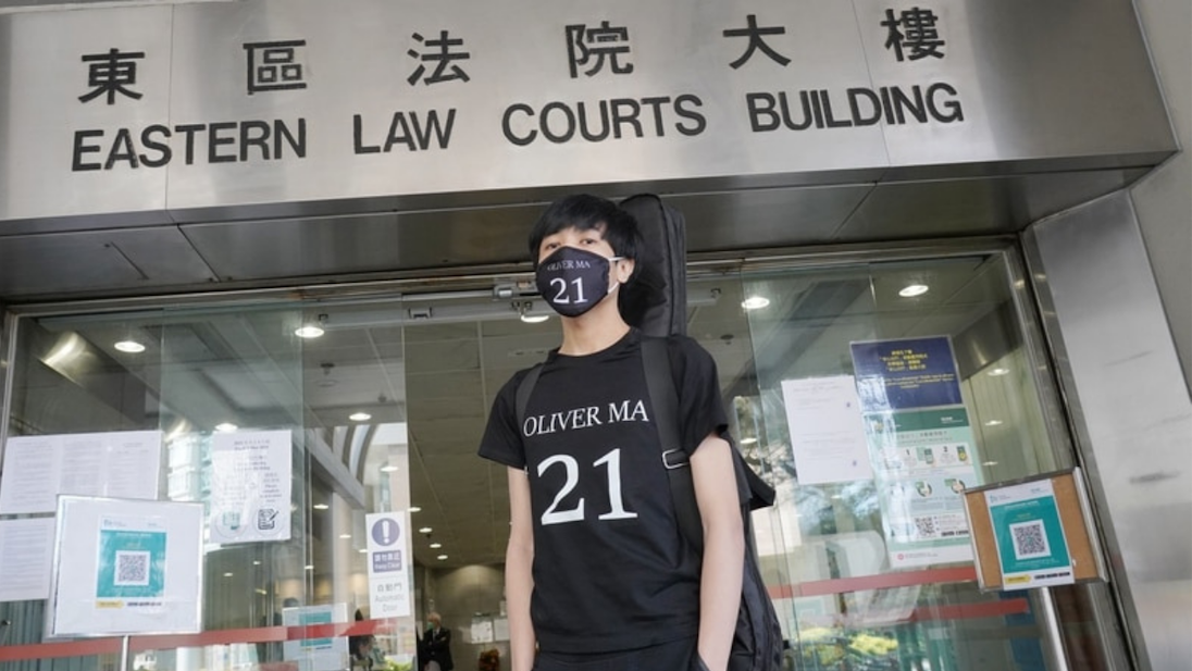 Oliver Ma, 21, stands outside the Eastern Law Courts Building on Feb. 23, 2021. Photo via Apple Daily