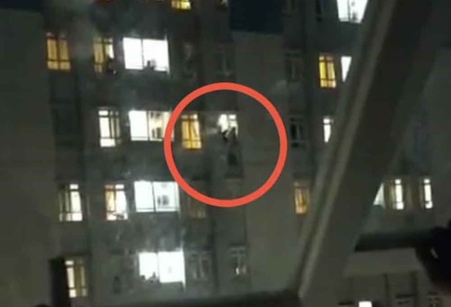 Video woman showing a woman standing on a ledge in a suicide attempt at Jakarta’s Wisma Atlet COVID-19 quarantine facility on Feb. 23, 2021. 