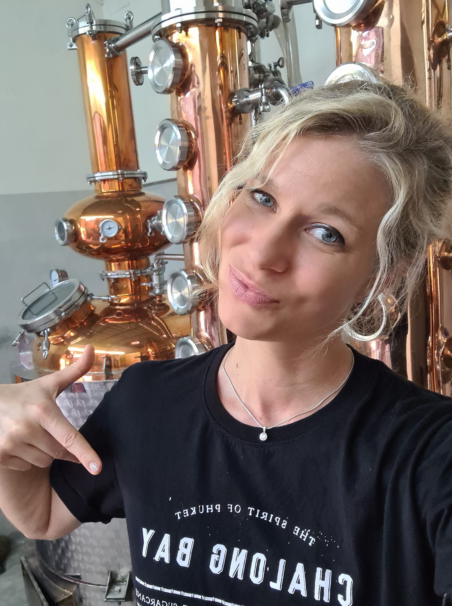 Marine Lucchini shows off her shirt and part of her distillery in Phuket.
