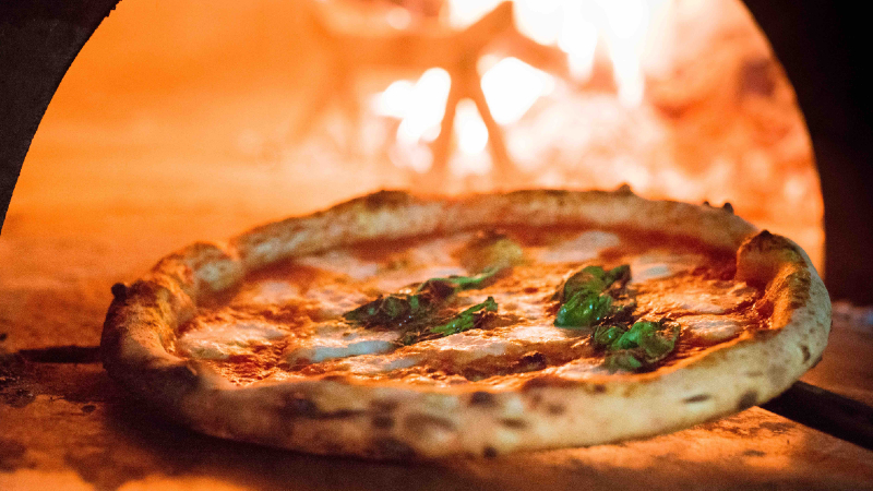 A pizza being taken out of the oven at Tanjong Katong’s 800° Woodfired Kitchen. Photo: 800° Woodfired Kitchen
