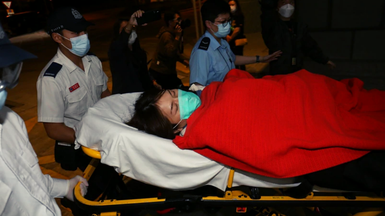 Activist Clarisse Yeung passed out 13 hours into the hearing, which began Monday noon. Photo via Apple Daily