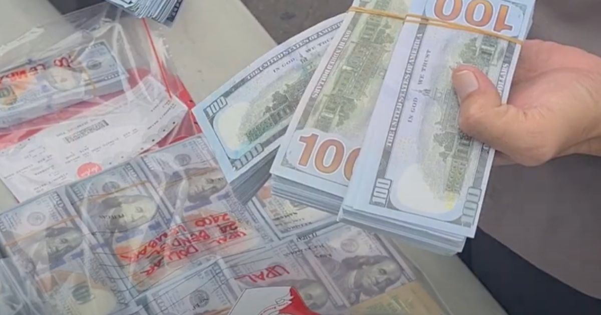 The suspects intended to deposit 15,000 one hundred US dollar bills. Screengrab: Youtube/Humas Polrestabes Surabaya